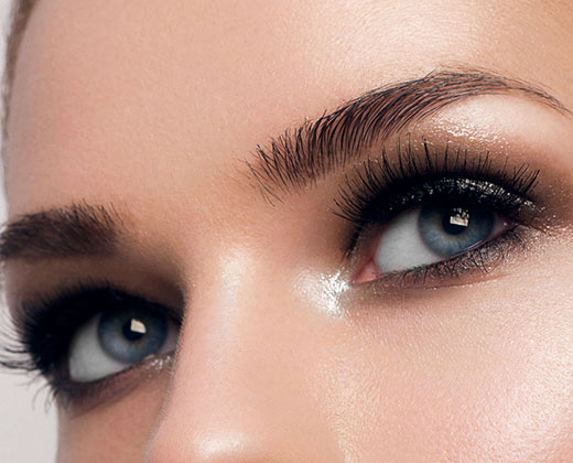 Macro shot of woman's beautiful eye with extremely long eyelashes. Sexy view, sensual look. Female eye with long eyelashes