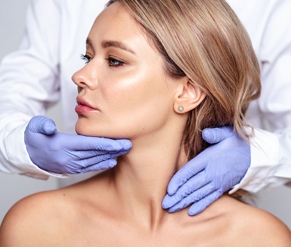 Close up portrait of young blonde woman with cosmetologyst hands