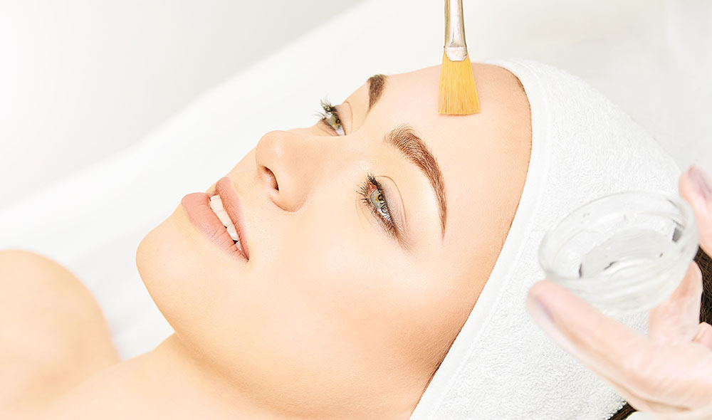 Facial brush peel retinol treatment. Beauty woman peeling procedure. Cosmetology young girl therapy.Hyaluronic acid.